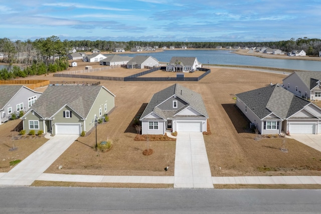 bird's eye view featuring a water view and a residential view