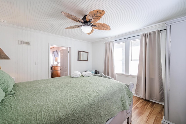 bedroom with ceiling fan, light wood-type flooring, and ornamental molding