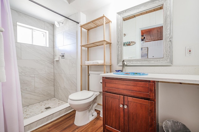 bathroom featuring toilet, vanity, a shower with shower curtain, and hardwood / wood-style flooring