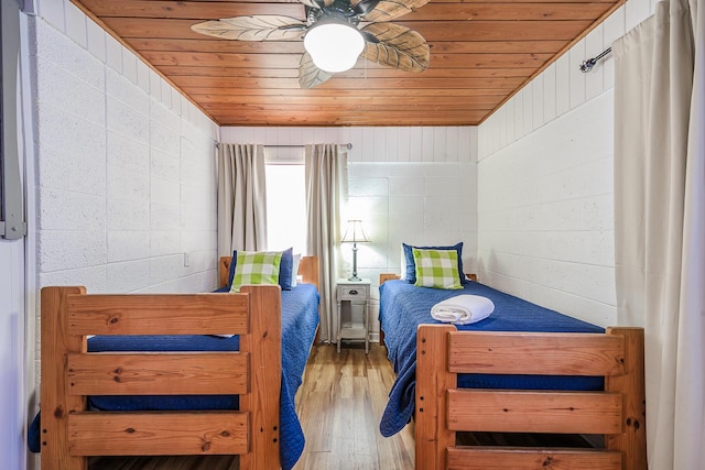 bedroom featuring wood-type flooring, ceiling fan, wood walls, and wood ceiling