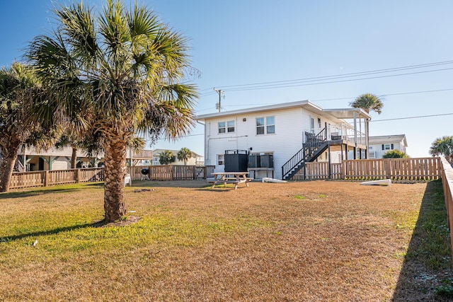 back of property featuring a lawn