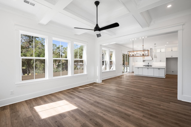 unfurnished living room featuring a healthy amount of sunlight and dark wood-type flooring