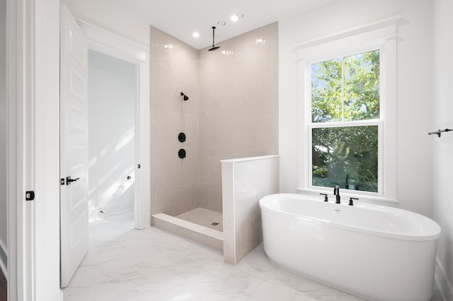 bathroom with plenty of natural light and shower with separate bathtub