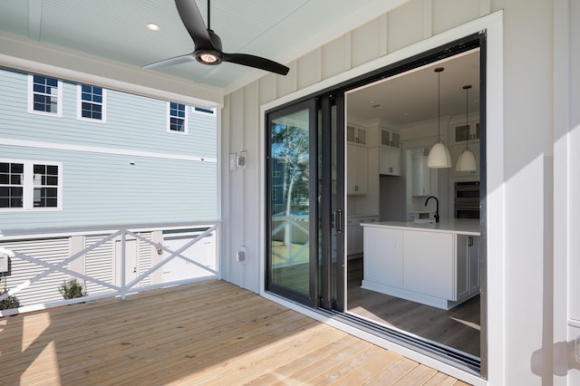 wooden deck with ceiling fan and sink