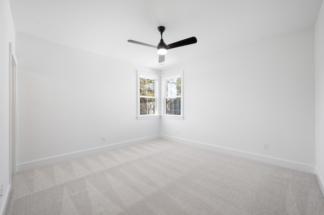 spare room featuring light colored carpet and ceiling fan