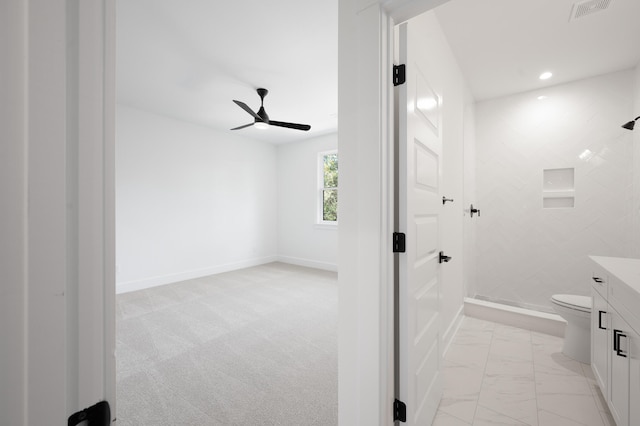 bathroom featuring ceiling fan, vanity, and toilet