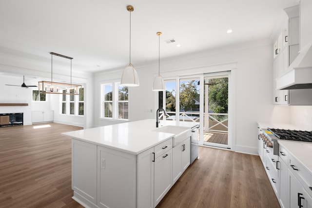 kitchen with white cabinetry, a kitchen island with sink, sink, and appliances with stainless steel finishes