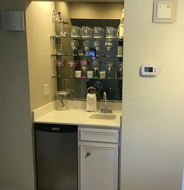 bar featuring dishwashing machine and sink