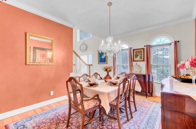 dining room with a notable chandelier, light wood-type flooring, and ornamental molding