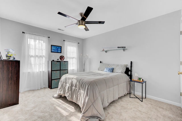 bedroom featuring ceiling fan and light carpet