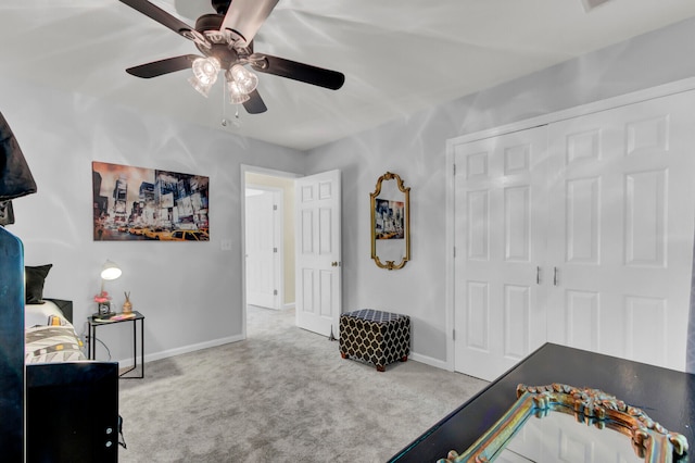 bedroom with ceiling fan, carpet, and a closet