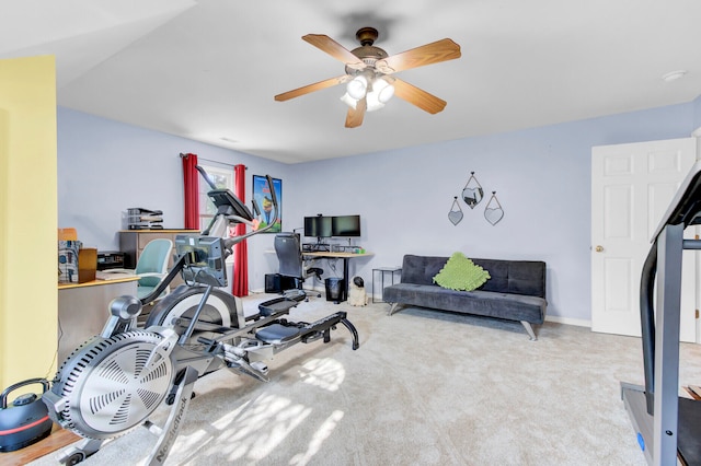 exercise room with ceiling fan and light carpet