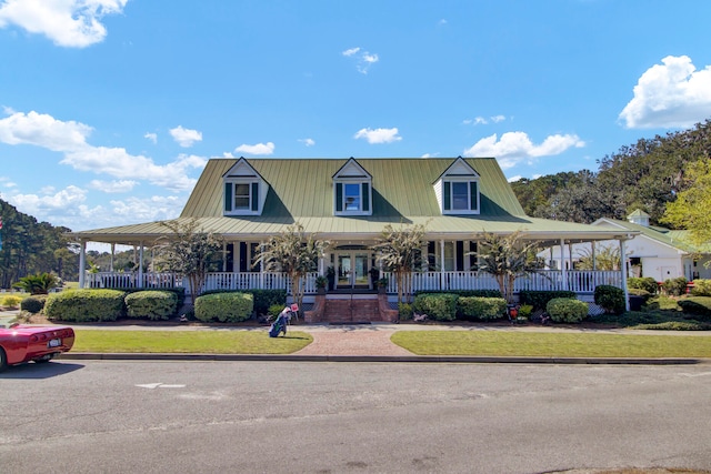 farmhouse-style home with a front yard and covered porch