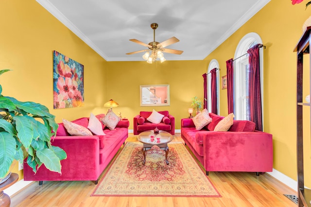 living room featuring ceiling fan, crown molding, and light hardwood / wood-style floors