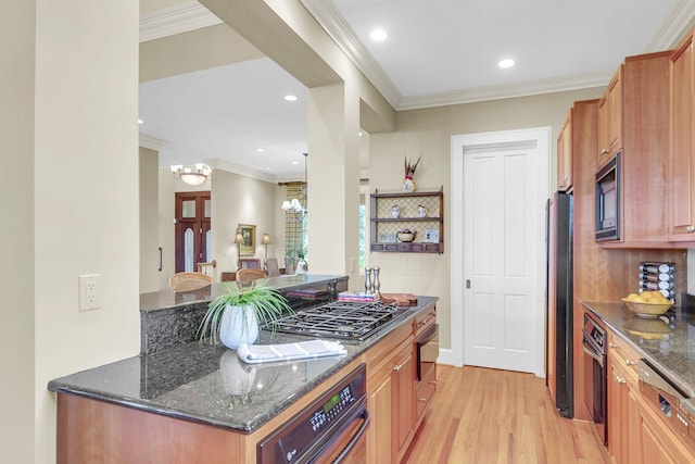 kitchen with crown molding, black appliances, light wood-type flooring, and dark stone counters