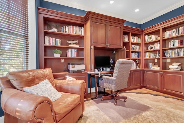 office with ornamental molding and light hardwood / wood-style floors