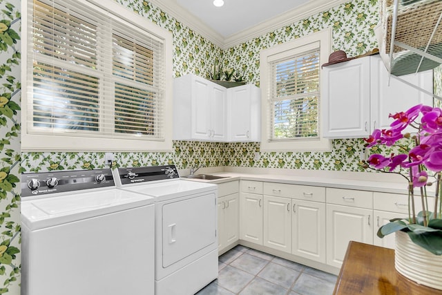 laundry room featuring cabinets, washer and clothes dryer, crown molding, sink, and light tile patterned flooring