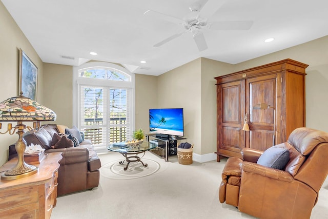 living room featuring light colored carpet and ceiling fan