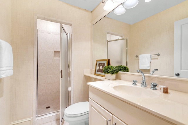 bathroom with vanity, toilet, and an enclosed shower