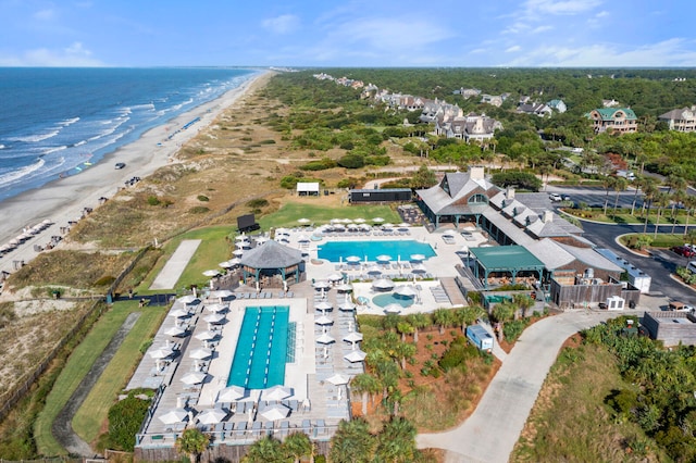 birds eye view of property featuring a beach view and a water view