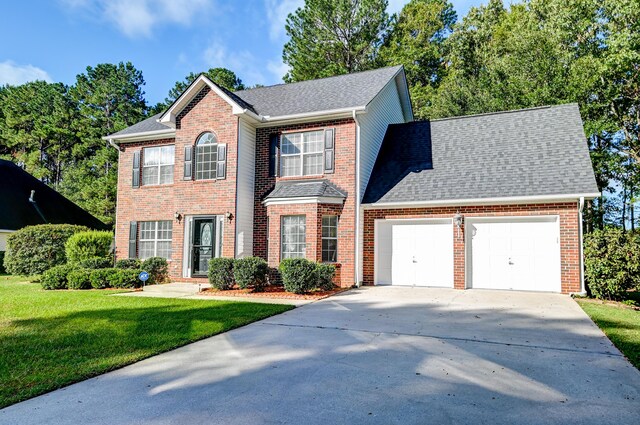 view of front of house with a front yard and a garage