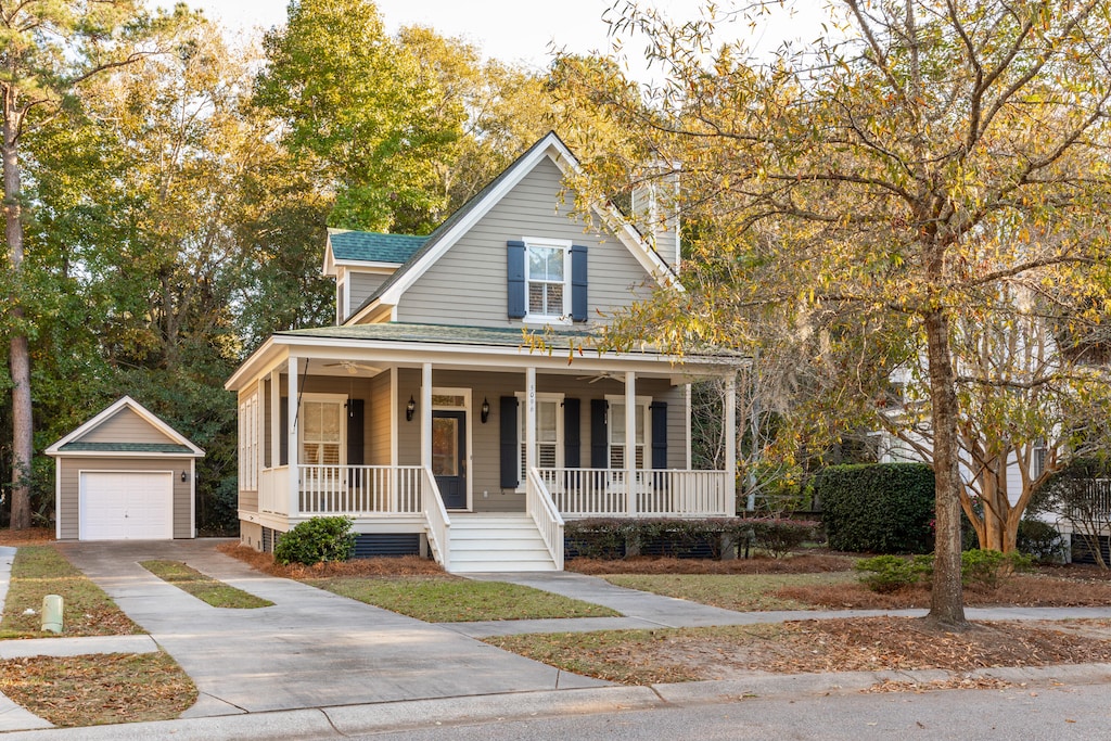 view of front of home with an outbuilding, a porch, and a garage