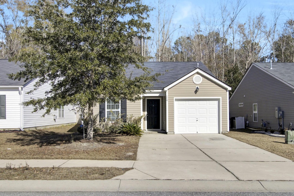 view of front facade featuring a garage and cooling unit