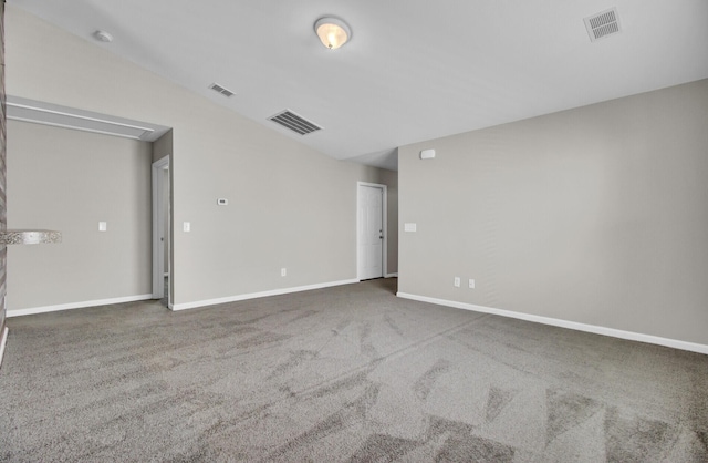 carpeted spare room featuring lofted ceiling