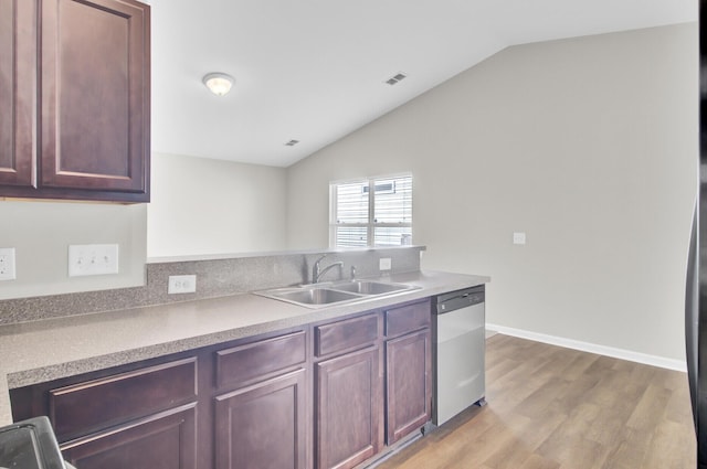 kitchen with stainless steel dishwasher, sink, vaulted ceiling, and light hardwood / wood-style flooring