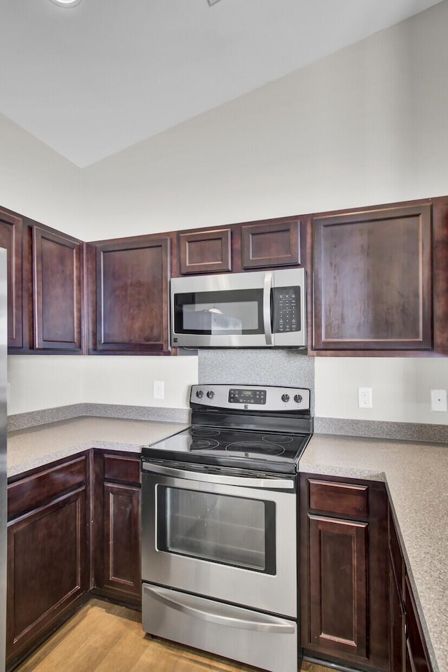 kitchen featuring stainless steel appliances and light hardwood / wood-style flooring