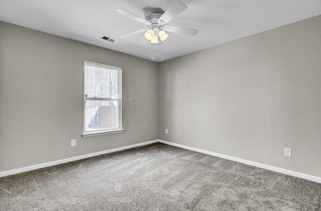 spare room featuring ceiling fan and carpet