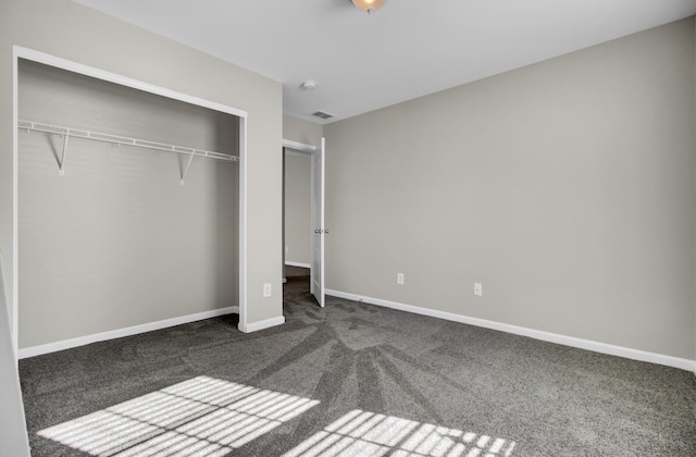 unfurnished bedroom with carpet floors and a closet