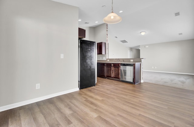 kitchen featuring dishwasher, dark brown cabinets, black fridge, pendant lighting, and light hardwood / wood-style flooring