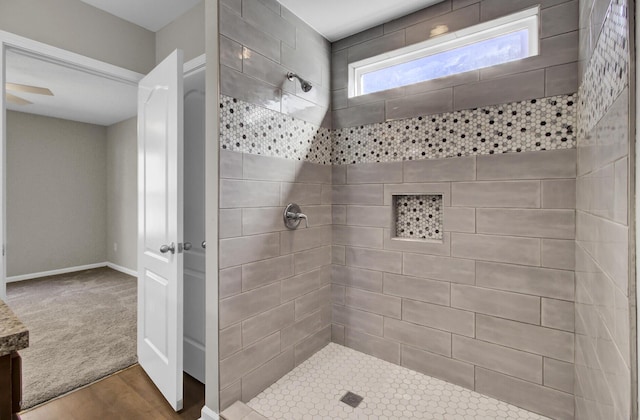 bathroom featuring a tile shower and hardwood / wood-style floors