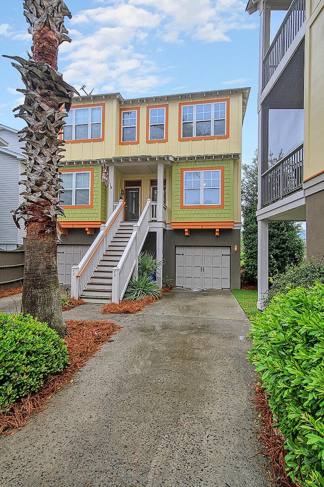 204 Michigan Ave Unit D2, Folly Beach, SC 29439 - view of front of home featuring stairway, driveway, and a garage