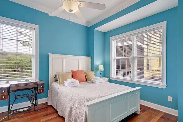 bedroom with ornamental molding, multiple windows, hardwood / wood-style floors, and ceiling fan