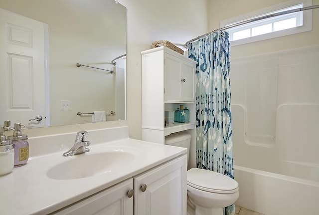 full bathroom with tile patterned floors, vanity, shower / bath combo with shower curtain, and toilet