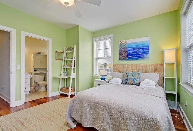 bedroom with hardwood / wood-style floors, ensuite bath, and ceiling fan