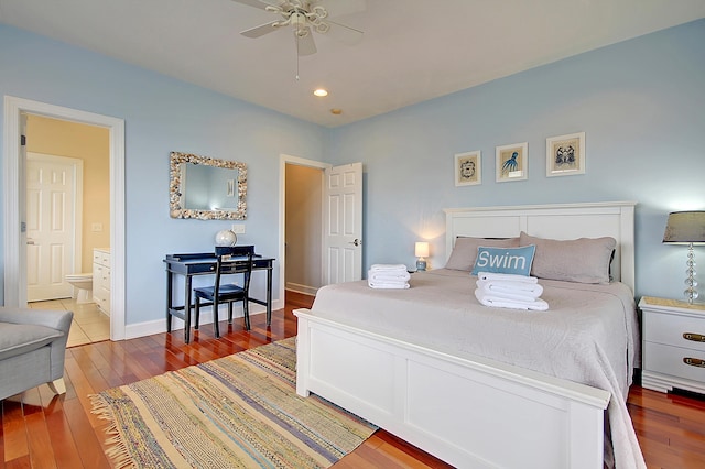 bedroom featuring ensuite bath, wood-type flooring, and ceiling fan