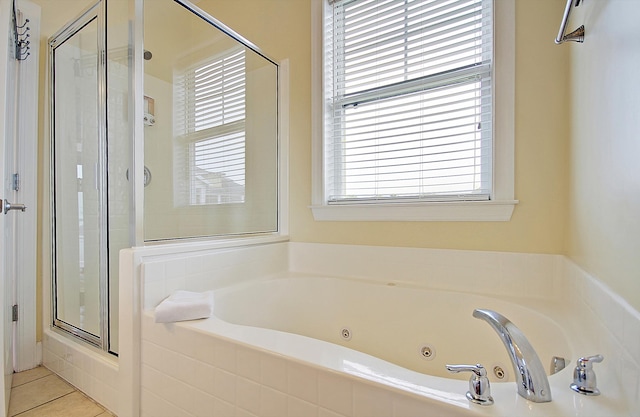 bathroom featuring tile patterned floors and separate shower and tub