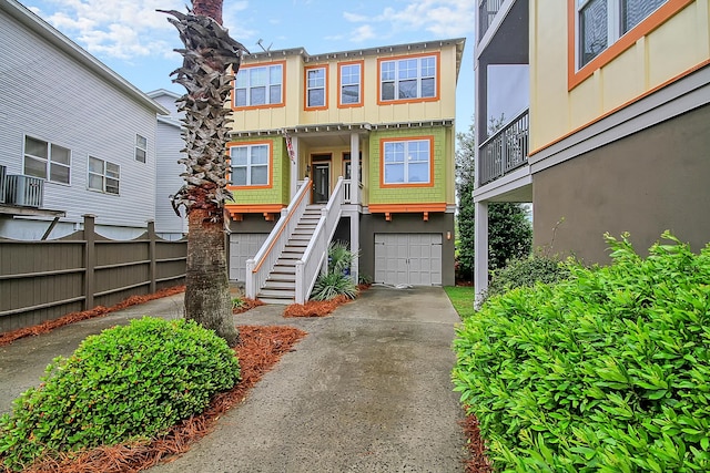 204 Michigan Ave Unit D2, Folly Beach, SC 29439 - view of front of house with concrete driveway, a garage, stairway, and board and batten siding