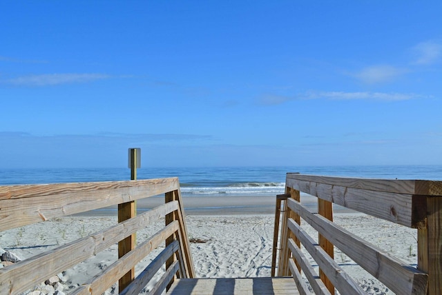 surrounding community featuring a view of the beach and a water view