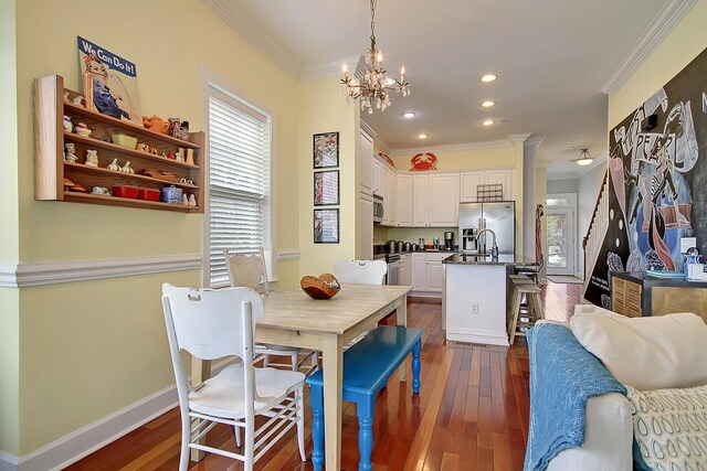 dining space featuring dark hardwood / wood-style floors, a chandelier, and crown molding