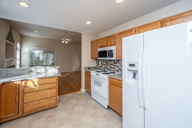 kitchen with decorative backsplash, white appliances, ceiling fan, light stone counters, and a textured ceiling