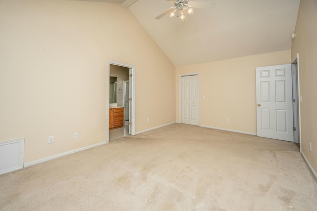 unfurnished bedroom with connected bathroom, high vaulted ceiling, light colored carpet, ceiling fan, and a closet