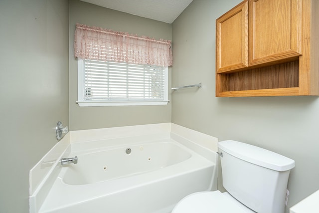 bathroom featuring toilet and a tub