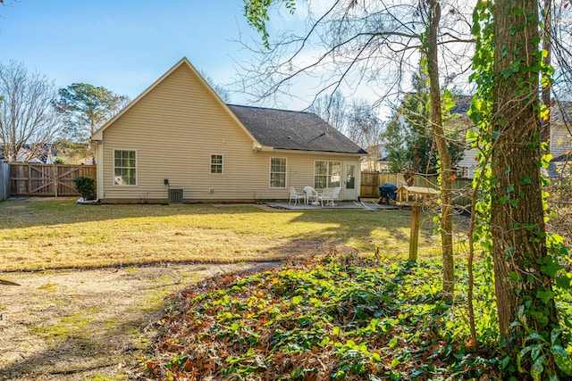 rear view of property featuring central AC, a patio area, and a lawn