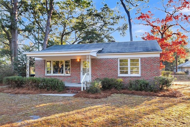 bungalow-style house featuring a front lawn and a porch