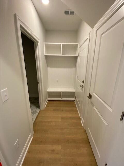 interior space featuring visible vents, baseboards, and wood finished floors