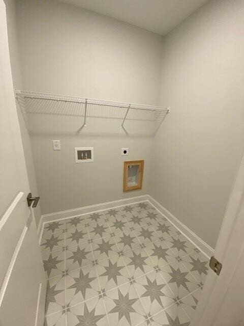 washroom featuring laundry area, baseboards, tile patterned floors, hookup for an electric dryer, and washer hookup